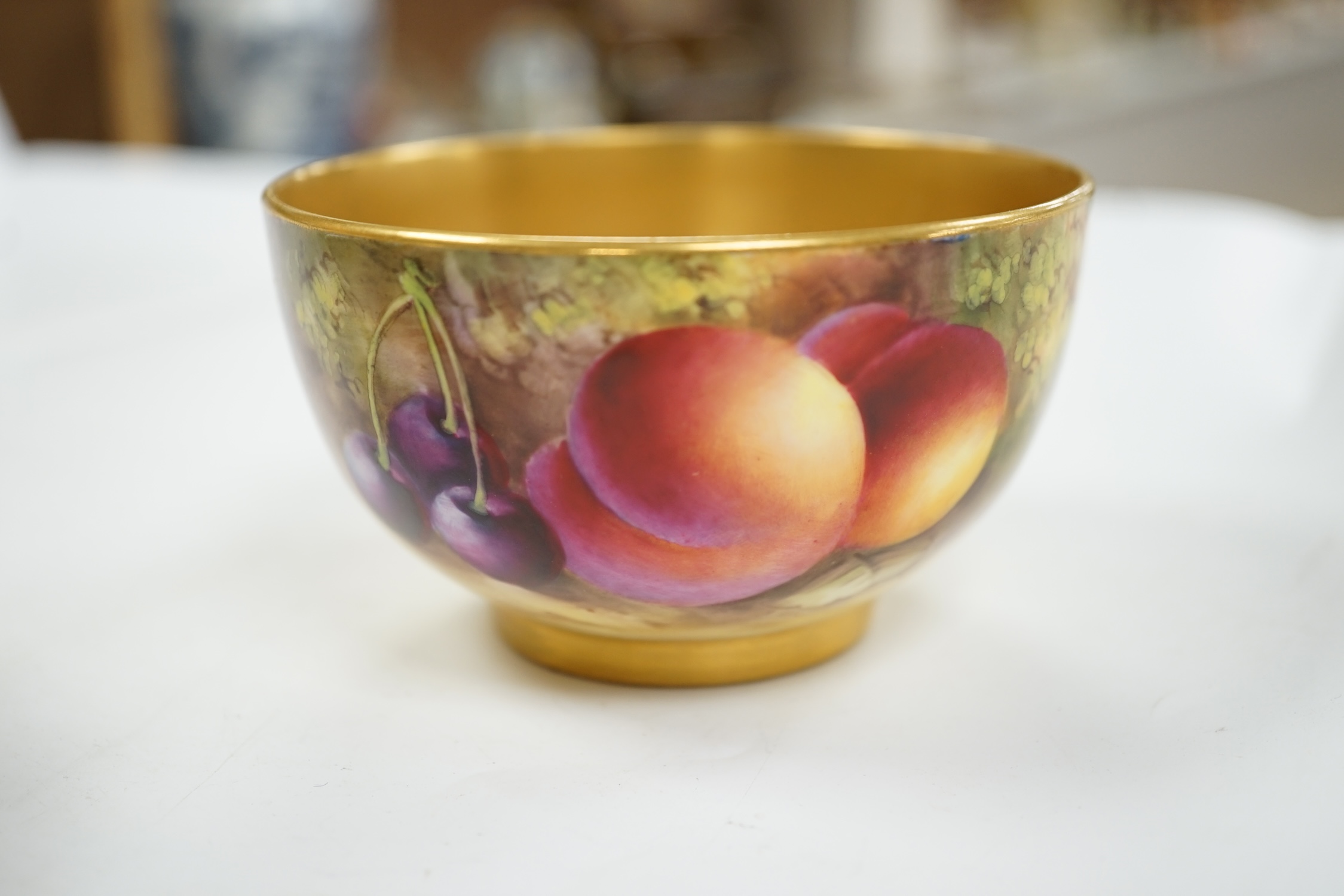 A Royal Worcester fruit painted bowl by Harry Ayrton, 9cm diameter. Condition - good